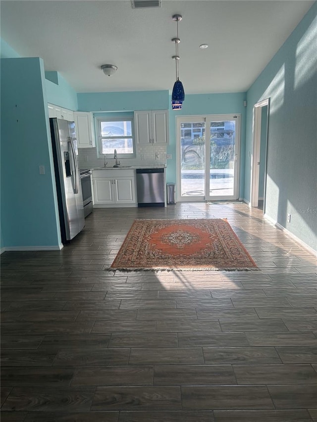 3339 Duar Ter, North Port, FL 34291 - kitchen featuring appliances with stainless steel finishes, wood finish floors, a sink, white cabinets, and recessed lighting