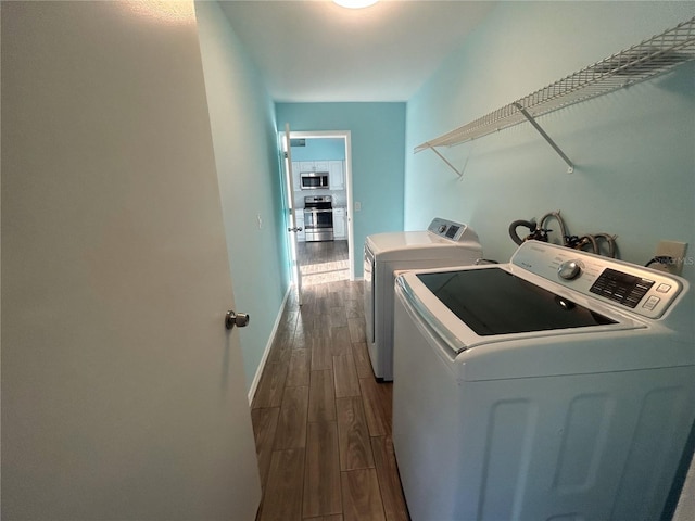 3339 Duar Ter, North Port, FL 34291 - laundry area featuring washer and dryer, dark wood finished floors, and baseboards