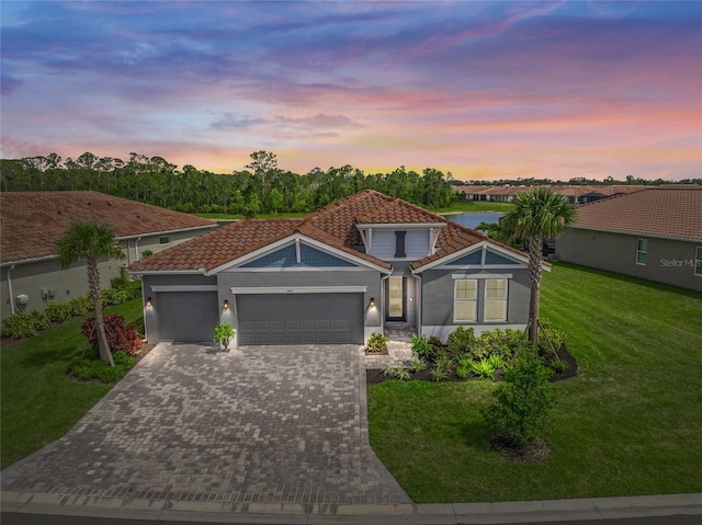 460 Daylily Blvd, Nokomis, FL 34275 - view of front of property with a tiled roof, an attached garage, driveway, a front yard, and stucco siding