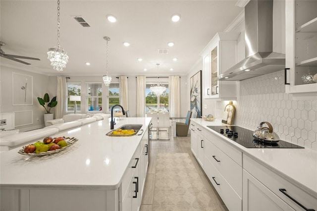 460 Daylily Blvd, Nokomis, FL 34275 - kitchen featuring a sink, wall chimney range hood, black electric cooktop, decorative backsplash, and light countertops