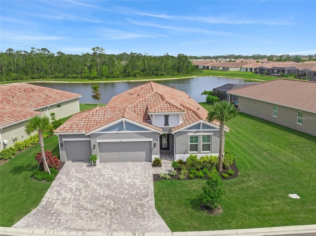 460 Daylily Blvd, Nokomis, FL 34275 - view of front of house with a tile roof, a water view, an attached garage, and driveway