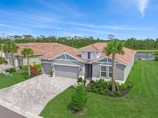 460 Daylily Blvd, Nokomis, FL 34275 - view of front of home with a garage, a tiled roof, stucco siding, decorative driveway, and a front lawn