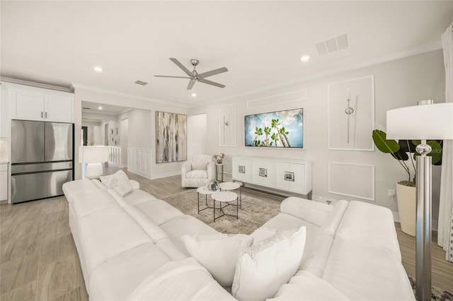 460 Daylily Blvd, Nokomis, FL 34275 - living room featuring a ceiling fan, recessed lighting, crown molding, and a decorative wall