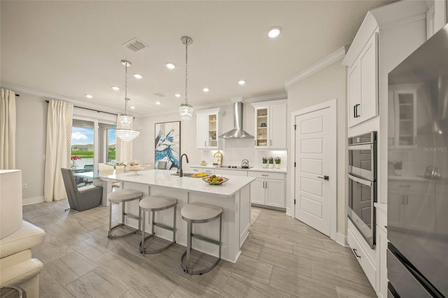 460 Daylily Blvd, Nokomis, FL 34275 - kitchen with wall chimney range hood, refrigerator, crown molding, double oven, and a kitchen breakfast bar