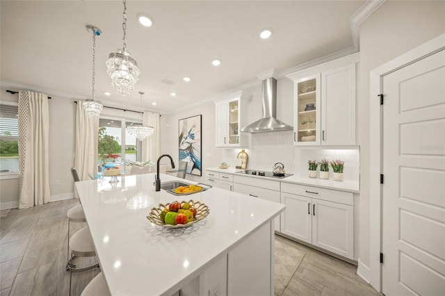 460 Daylily Blvd, Nokomis, FL 34275 - kitchen featuring wall chimney exhaust hood, a sink, recessed lighting, light countertops, and a kitchen island with sink