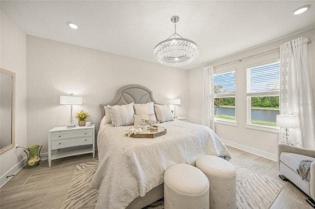 460 Daylily Blvd, Nokomis, FL 34275 - bedroom with baseboards, a chandelier, recessed lighting, wood finished floors, and a water view