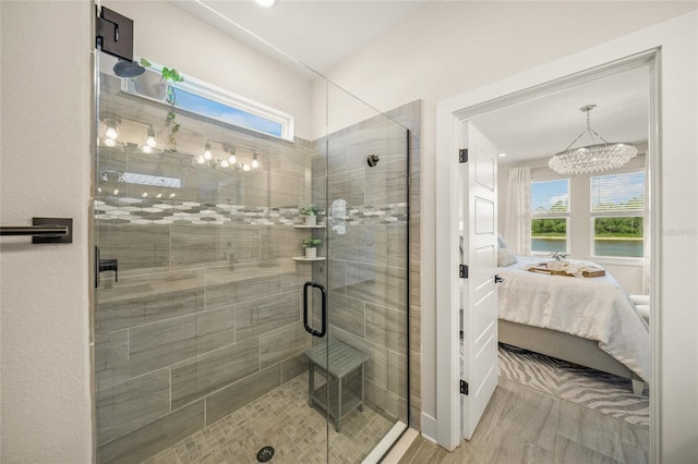 460 Daylily Blvd, Nokomis, FL 34275 - full bathroom with connected bathroom, a chandelier, a stall shower, and wood finished floors
