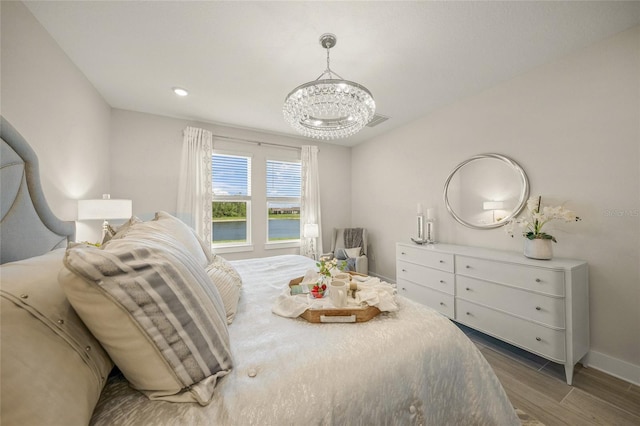 460 Daylily Blvd, Nokomis, FL 34275 - bedroom featuring wood finished floors, a chandelier, and baseboards