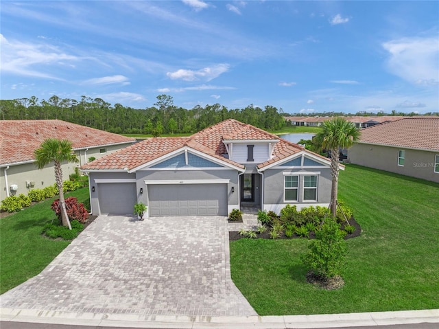 460 Daylily Blvd, Nokomis, FL 34275 - view of front of house featuring a tile roof, an attached garage, decorative driveway, a front lawn, and stucco siding