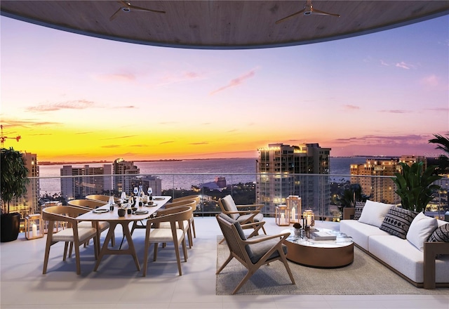 290 Cocoanut Ave Unit 6A, Sarasota, FL 34236 - patio terrace at dusk featuring outdoor lounge area, a ceiling fan, a water view, and a balcony