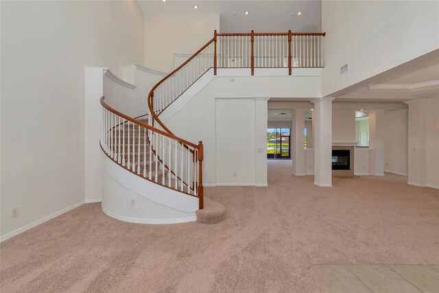 4307 70th Ave E, Ellenton, FL 34222 - stairs featuring carpet flooring, a towering ceiling, baseboards, recessed lighting, and a multi sided fireplace
