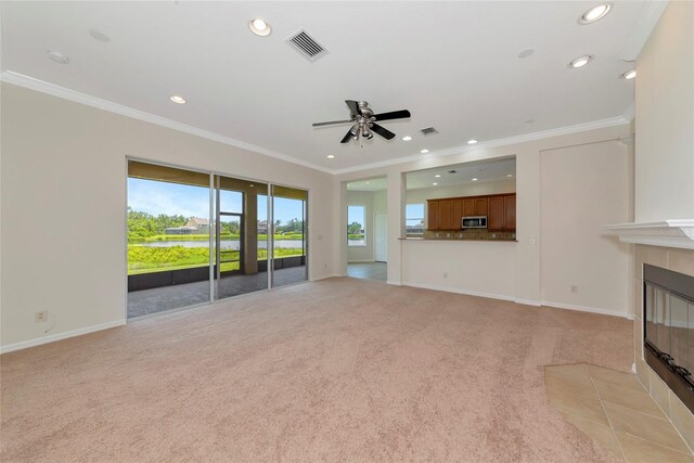 4307 70th Ave E, Ellenton, FL 34222 - unfurnished living room with light carpet, a tile fireplace, recessed lighting, a ceiling fan, and ornamental molding
