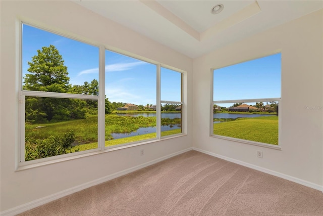 4307 70th Ave E, Ellenton, FL 34222 - unfurnished room with a water view, carpet, baseboards, and a raised ceiling