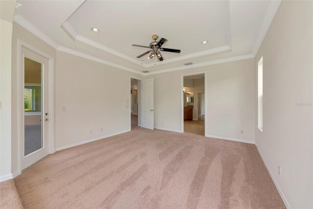 4307 70th Ave E, Ellenton, FL 34222 - unfurnished bedroom with a tray ceiling, light carpet, ornamental molding, baseboards, and recessed lighting