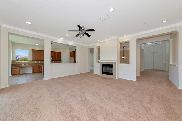 4307 70th Ave E, Ellenton, FL 34222 - unfurnished living room featuring light carpet, recessed lighting, a tile fireplace, ceiling fan, and crown molding