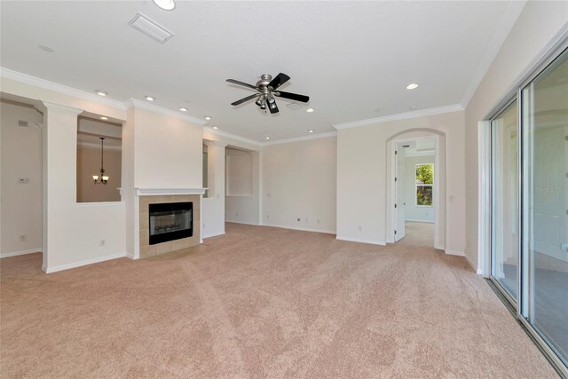 4307 70th Ave E, Ellenton, FL 34222 - unfurnished living room with a ceiling fan, light colored carpet, a fireplace, arched walkways, and crown molding