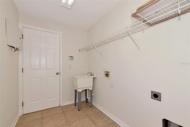 4307 70th Ave E, Ellenton, FL 34222 - washroom with hookup for an electric dryer, hookup for a washing machine, light tile patterned flooring, and baseboards