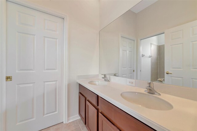 4307 70th Ave E, Ellenton, FL 34222 - bathroom featuring double vanity, tile patterned floors, baseboards, and a shower