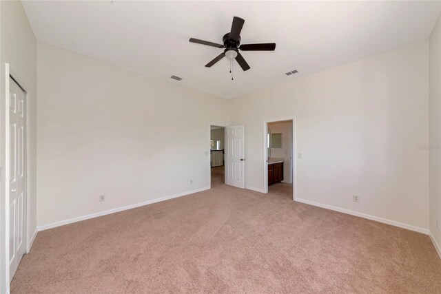 4307 70th Ave E, Ellenton, FL 34222 - unfurnished bedroom featuring light carpet, baseboards, ensuite bath, and ceiling fan