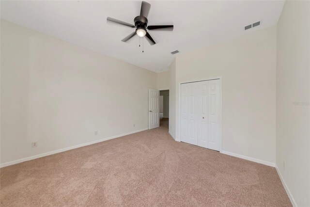 4307 70th Ave E, Ellenton, FL 34222 - unfurnished bedroom with light carpet, baseboards, lofted ceiling, a closet, and ceiling fan