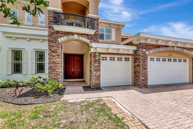 4307 70th Ave E, Ellenton, FL 34222 - view of front of home with a balcony, stucco siding, decorative driveway, and stone siding