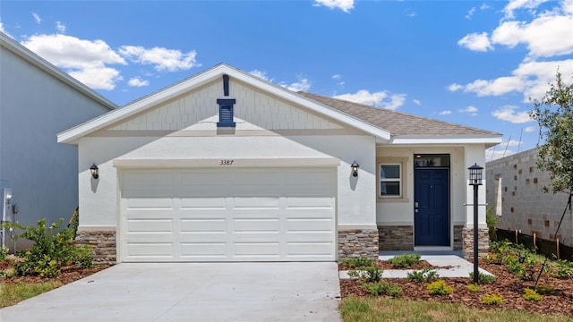 3218 Bitterroot Ln, Lakewood Ranch, FL 34211 - view of front of property with stone siding, driveway, a garage, and stucco siding