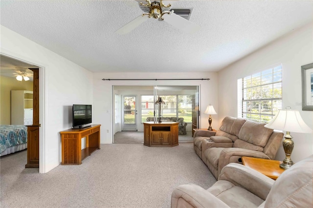 9412 Concord Cir, Bradenton, FL 34210 - living area with ceiling fan, light carpet, and a textured ceiling