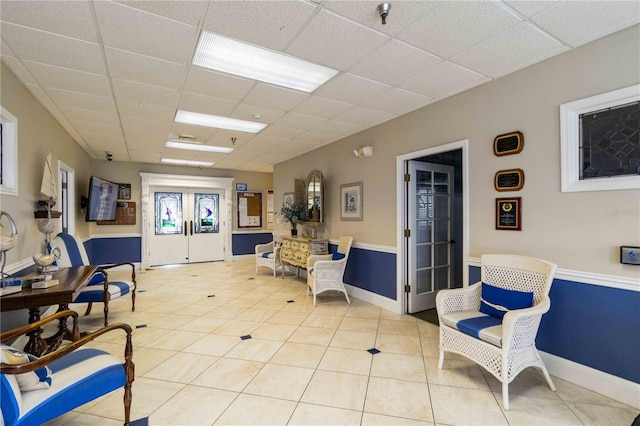 9412 Concord Cir, Bradenton, FL 34210 - sitting room featuring a drop ceiling, light tile patterned floors, and baseboards