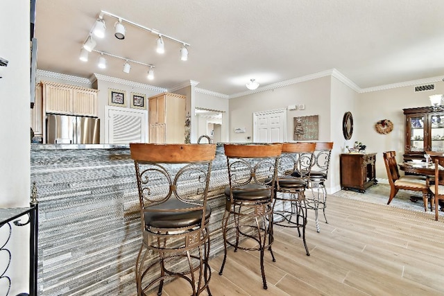 2825 Terra Ceia Bay Blvd Unit 1804, Palmetto, FL 34221 - kitchen featuring freestanding refrigerator, light wood-style flooring, ornamental molding, and track lighting