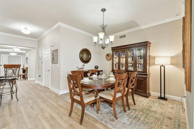 2825 Terra Ceia Bay Blvd Unit 1804, Palmetto, FL 34221 - dining room featuring a chandelier, ornamental molding, and light wood finished floors