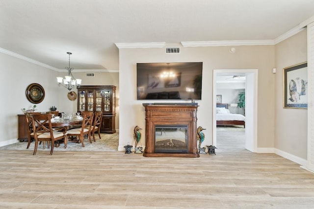 2825 Terra Ceia Bay Blvd Unit 1804, Palmetto, FL 34221 - living area with wood finished floors, ornamental molding, a chandelier, and a glass covered fireplace