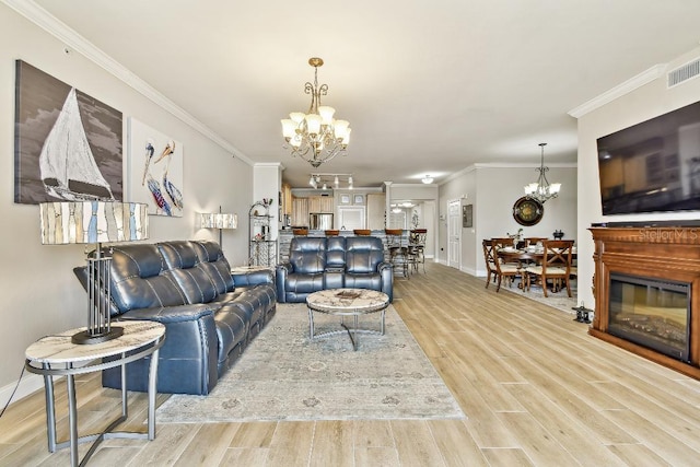 2825 Terra Ceia Bay Blvd Unit 1804, Palmetto, FL 34221 - living room featuring a chandelier, light wood finished floors, and ornamental molding
