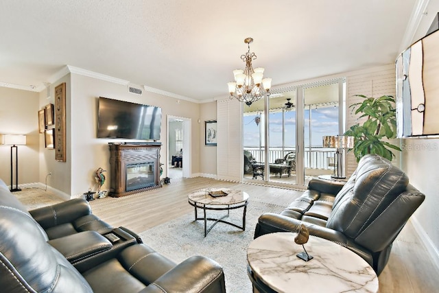 2825 Terra Ceia Bay Blvd Unit 1804, Palmetto, FL 34221 - living room with a chandelier, wood finished floors, a glass covered fireplace, and ornamental molding
