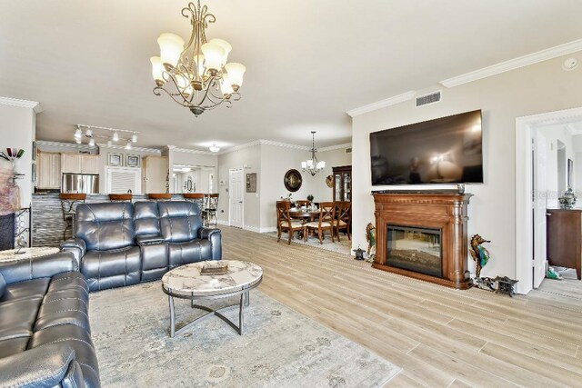 2825 Terra Ceia Bay Blvd Unit 1804, Palmetto, FL 34221 - living area with a chandelier, wood finished floors, and ornamental molding
