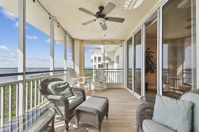 2825 Terra Ceia Bay Blvd Unit 1804, Palmetto, FL 34221 - sunroom with a water view, a wall of windows, wood finished floors, and a textured ceiling