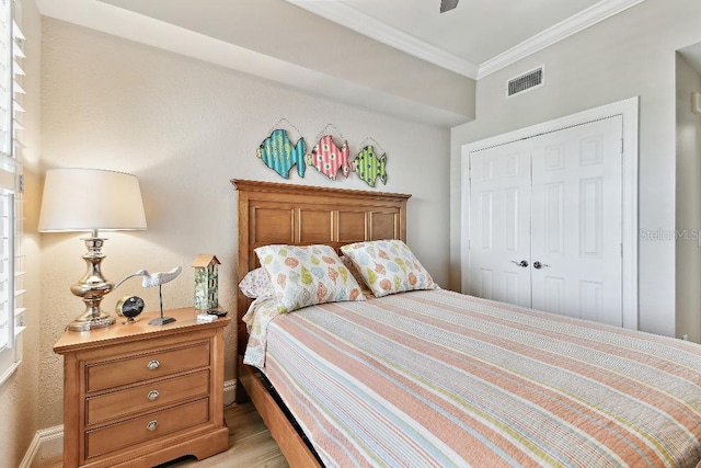 2825 Terra Ceia Bay Blvd Unit 1804, Palmetto, FL 34221 - bedroom with ornamental molding, a closet, and light wood finished floors