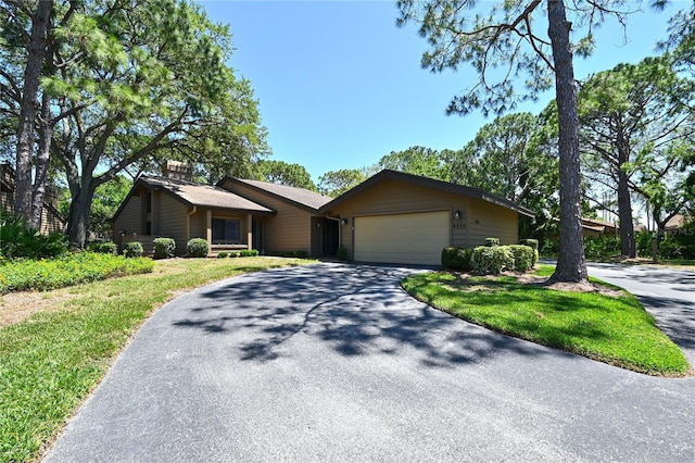 4555 Chandlers Forde Unit 47, Sarasota, FL 34235 - ranch-style house featuring driveway, a garage, a front lawn, and a chimney