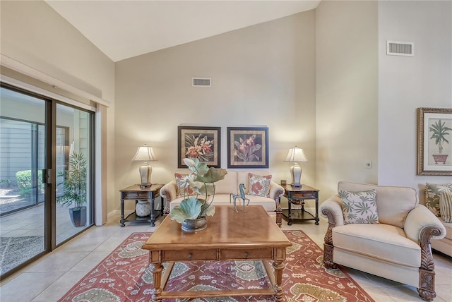 4555 Chandlers Forde Unit 47, Sarasota, FL 34235 - living room featuring high vaulted ceiling and light tile patterned floors