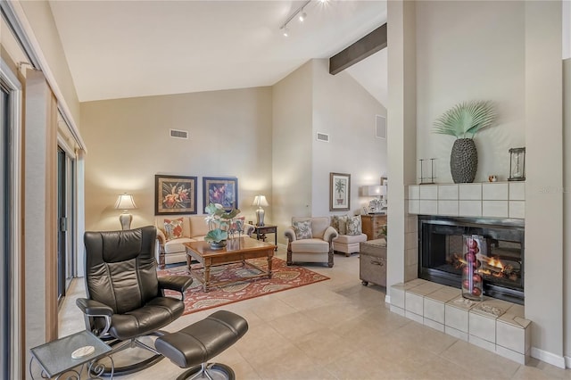 4555 Chandlers Forde Unit 47, Sarasota, FL 34235 - living room with rail lighting, a fireplace, high vaulted ceiling, and beamed ceiling