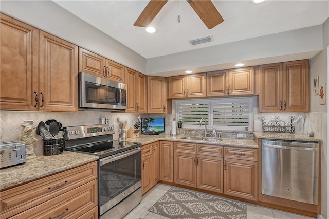 4555 Chandlers Forde Unit 47, Sarasota, FL 34235 - kitchen featuring stainless steel appliances, a sink, a ceiling fan, light stone countertops, and recessed lighting