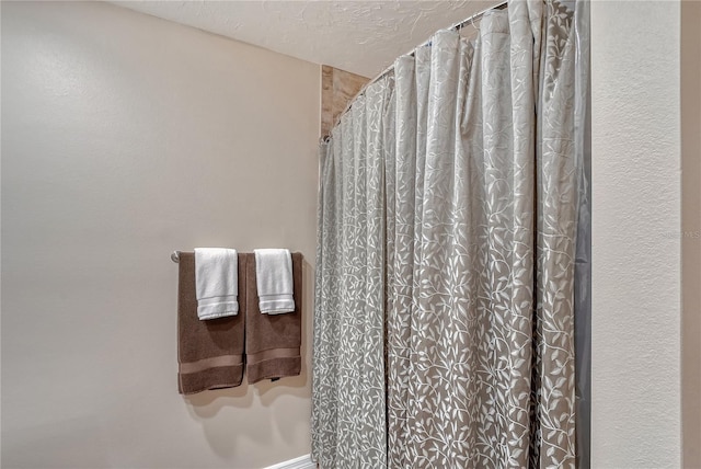 4555 Chandlers Forde Unit 47, Sarasota, FL 34235 - full bathroom with a shower with shower curtain and a textured ceiling