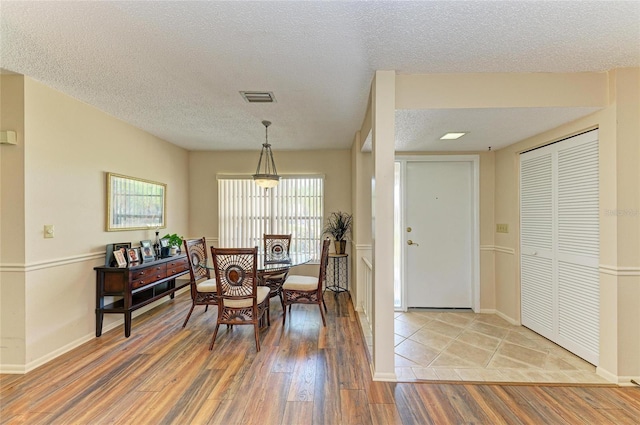 6804 19th Ave W, Bradenton, FL 34209 - dining area with light wood-type flooring and a textured ceiling