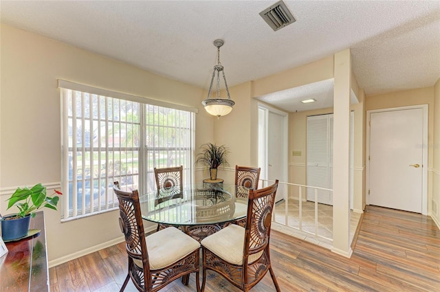 6804 19th Ave W, Bradenton, FL 34209 - dining space with wood finished floors and a textured ceiling