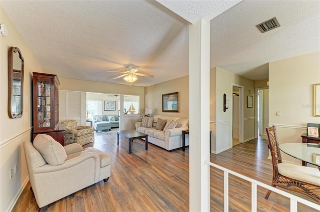 6804 19th Ave W, Bradenton, FL 34209 - living room with a textured ceiling, ceiling fan, and dark wood-style floors