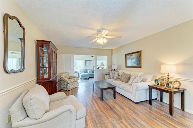 6804 19th Ave W, Bradenton, FL 34209 - living room featuring ceiling fan, light wood-type flooring, and a textured ceiling