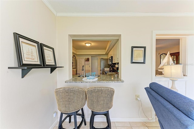 6804 19th Ave W, Bradenton, FL 34209 - tiled dining area featuring crown molding and baseboards