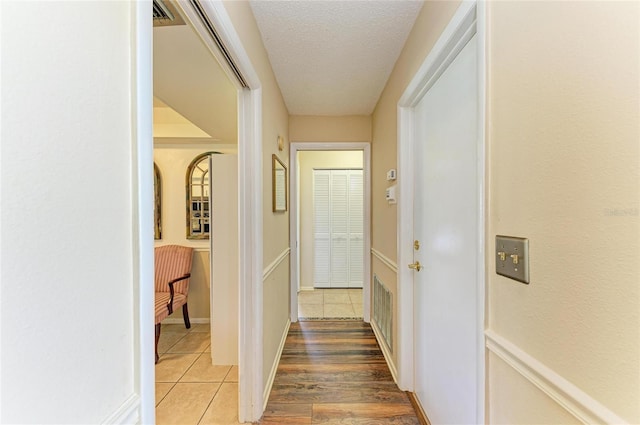 6804 19th Ave W, Bradenton, FL 34209 - corridor with light tile patterned flooring and a textured ceiling