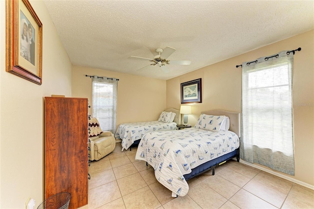 6804 19th Ave W, Bradenton, FL 34209 - bedroom featuring light tile patterned flooring, a textured ceiling, and a ceiling fan