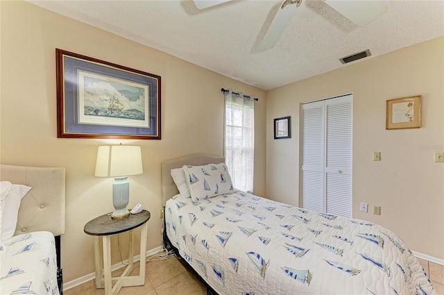 6804 19th Ave W, Bradenton, FL 34209 - bedroom with a closet, a textured ceiling, tile patterned flooring, and a ceiling fan
