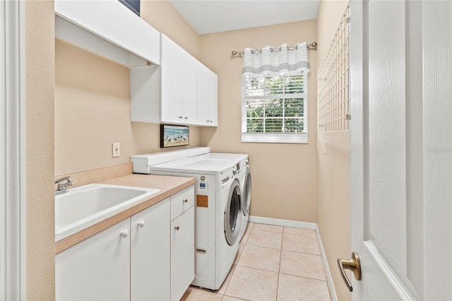 866 Oak Briar Ln, Osprey, FL 34229 - laundry area featuring cabinet space, washing machine and clothes dryer, light tile patterned flooring, and baseboards
